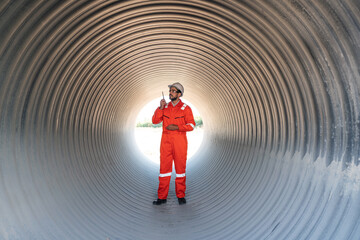 Mechanical engineer wearing safety uniform checking and inspection pipeline system.