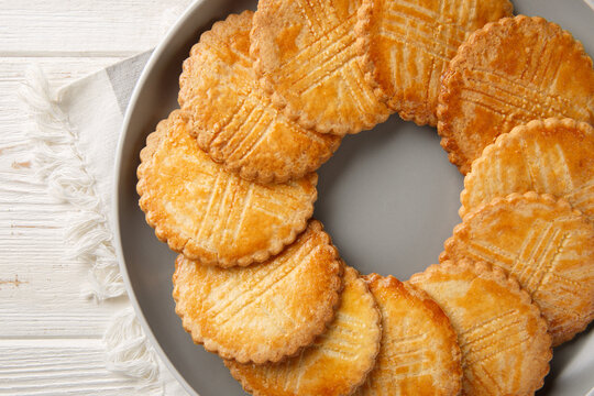 Sable Breton sweet-salty shortbread biscuits closeup on the plate on the table. Horizontal top view from above