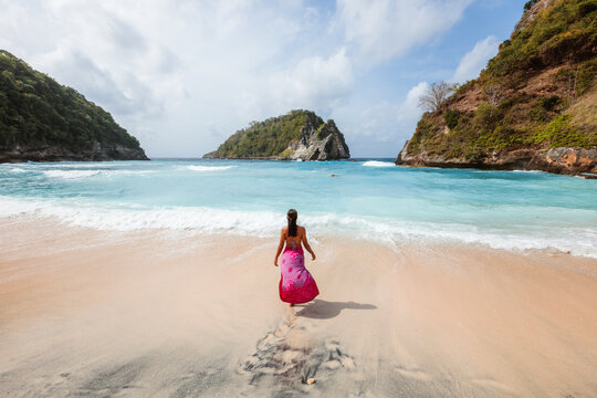 Asian woman with sarong at Atuh beach, Nusa Penida island, Bali, Indonesia