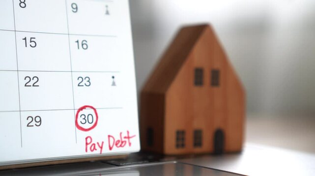  Close-up of a marked due date on the calendar as a reminder to pay monthly debt or mortgage for house or real estate, helping manage finances and avoid missing loan payments