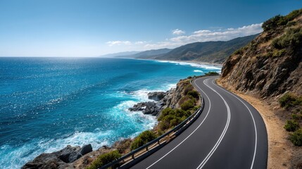 An empty asphalt road running along the edge of a rugged coastline