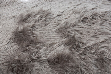 Gray faux fur surface as texture. Soft fur fabric with long hairs