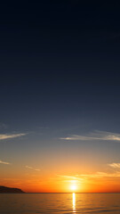 Sunrise over the sea with gentle waves and fading stars in a peaceful, dreamy atmosphere