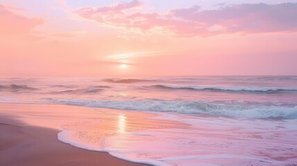 Obraz premium Soft pink sunset over the ocean with gentle waves washing onto the shore creating a peaceful scene