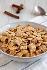 Crunchy Cinnamon Sugar Breakfast Cereal with Milk in a Bowl, side view.