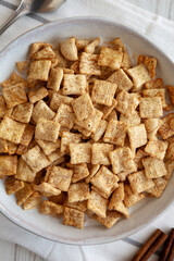 Crunchy Cinnamon Sugar Breakfast Cereal with Milk in a Bowl, top view.