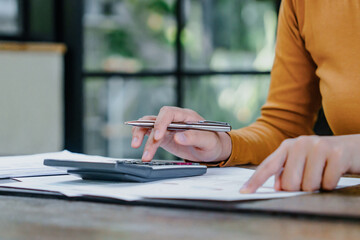 Close up of hand using calculator calculating personal finance for income and expenses