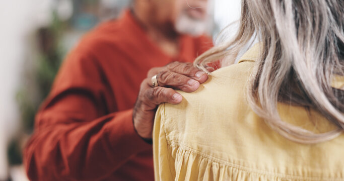 Home, old couple and hand on shoulder for empathy, support and comfort to partner with grief. Closeup, senior woman and elderly man with sympathy for loss, compassion and kindness with love in house