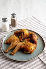 Homemade Grilled Chicken Tabaka on a Plate, side view. Space for text.