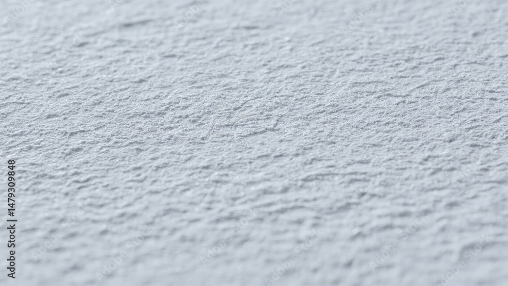Poster close up view of a textured light gray surface with natural depth and subtle details