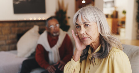 Senior woman, stress and conflict with man on sofa in home with anger, ignore and retirement in...