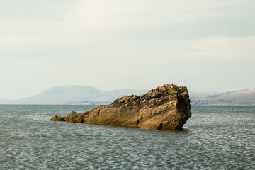 Fototapeta premium A cliff jutting out of the water in Irish waters, Turtle Rock