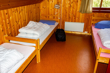 Cottage vacation interior decoration. Bedroom with beds in Norway.