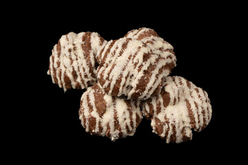 Profiteroles with coconut cream on a black background.