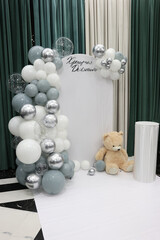 A background with balloons on a baptism theme for taking pictures of people.