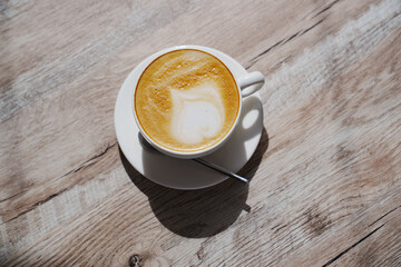 White classic cup with coffee and foam.