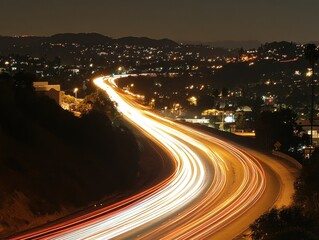 Obraz premium Highway traffic streaks through the night in Los Angeles California aerial view long exposure urban landscape