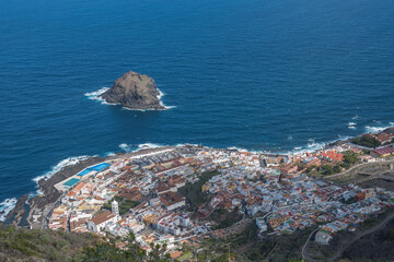 Aerial view of old town Garachico from Mirador de Garachico view point. Colorful houses and harbor. Ocean shore with lava rock pools. Popular tourist destination, Tenerife Canary Islands.