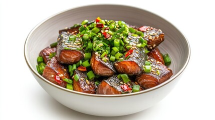 Bowl of marinated herring pieces topped with fresh green onions, isolated on white in a clean overhead shot