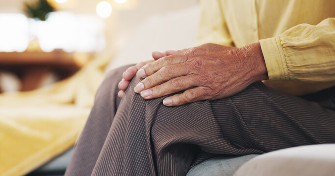 Hands, knee pain and massage with mature person on sofa in living room of home for arthritis. Accident, inflammation or joint injury and senior in apartment with osteoarthritis or tendinitis