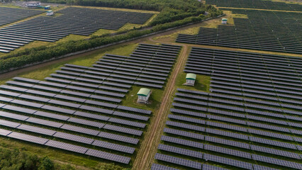 An aerial view of a solar power plant, also known as a solar park, is a large-scale photovoltaic...