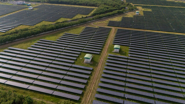 An aerial view of a solar power plant, also known as a solar park, is a large-scale photovoltaic (PV) system designed to supply commercial electricity to the grid.