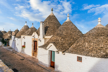 Touristic italian town near Bari of Alberobello with ancient beautiful buildings trulli with white...