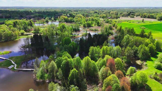 A Picturesque Region of Karst Lakes, Lush Forests, and a Canoe-shaped Observation Tower in Kirkilai, Biržai Regional Park, Lithuania - Aerial Drone Shot