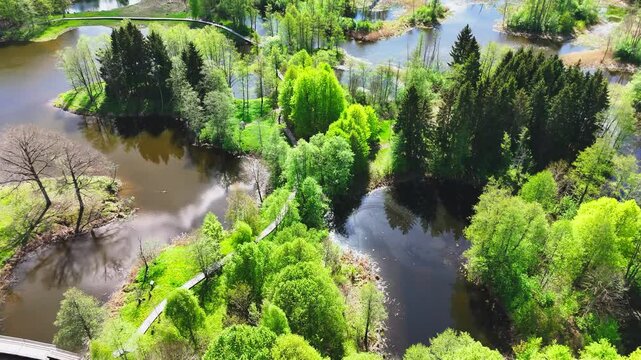 Biržai Regional Park, Lithuania - A Breathtaking View Showcases Winding Walkways, Serene Karst Lakes, and Richly Wooded Landscapes - Aerial Drone Shot