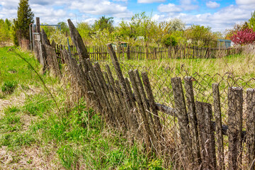 Old slanted wooden fence in the village
