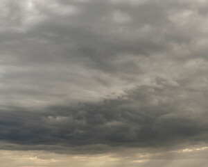Dramatic Heavy Clouds Form a Captivating Sky, Hinting at Potential Rain in the Early Evening Twilight