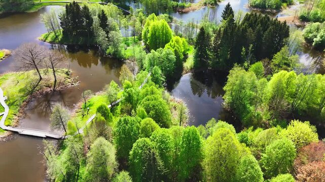 A Peaceful Landform Connected by Winding Bridges Lies Amid the Karst Lakes of Kirkilai in Biržai Regional Park, Lithuania - Aerial Drone Shot