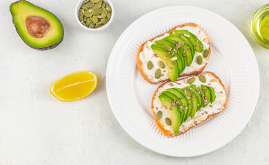 Healthy avocado toasts with sliced avocado, cheese for breakfast or lunch. Vegetarian food. Vegan menu. top view. copy space