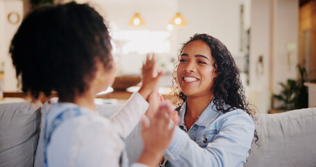 Games, mother and girl with hands together, smile and playing with fun for bonding in lounge. Family, home and parent on couch, mama and daughter with motor skills, excited and happy with love