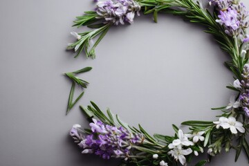 Delicate floral wreath arrangement on a gray background.