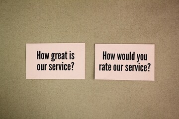 colored paper with question words Biased survey questions - How great is our service? Unbiased survey questions - How would you rate our service?