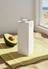 White carton juice box on yellow blanket by avocado