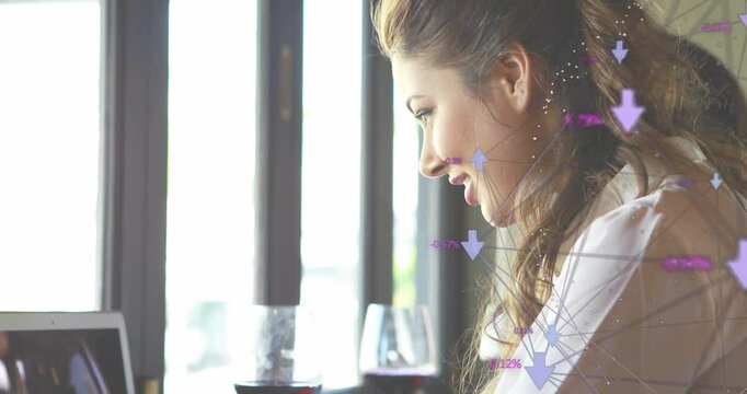 Woman analyzing business data at caf&eacute;, displaying purple infographic arrows and percentage points