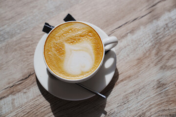 White classic cup with coffee and foam.