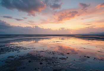 Fototapeta premium Sunset Over Coastal Landscape with Vibrant Sky and Reflection on Calm Ocean Water