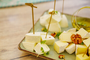 Cheese platter with sauces and honey on a plate.