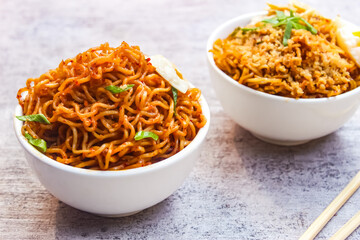 noodles in a bowl with two variants on the table	
