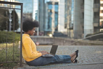 woman on the street uses a computer