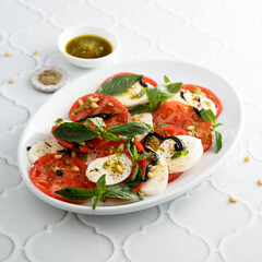 Traditional Caprese salad with pesto sauce