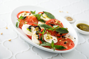 Traditional Caprese salad with pesto sauce