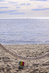 Obraz premium Beach Serenity with Colorful Ball and Rope