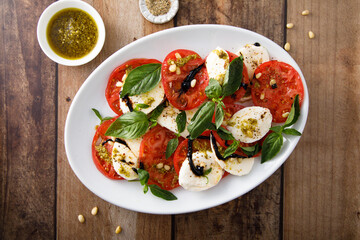 Traditional Caprese salad with pesto sauce