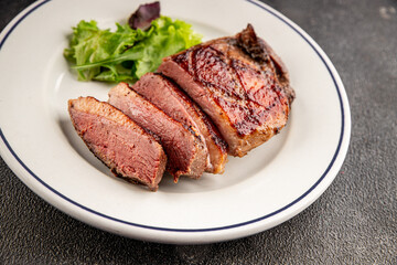 Duck breast roast meat poultry fresh delicious gourmet food background on the table rustic food top view copy space