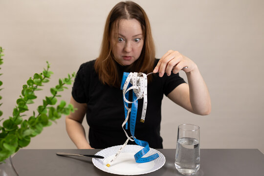 A woman is surprised to see an unusual dish made of measuring tapes, the concept of an eating disorder and an obsession with weight loss