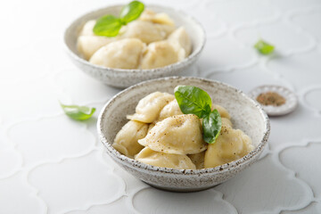 Homemade dumplings served with fresh basil